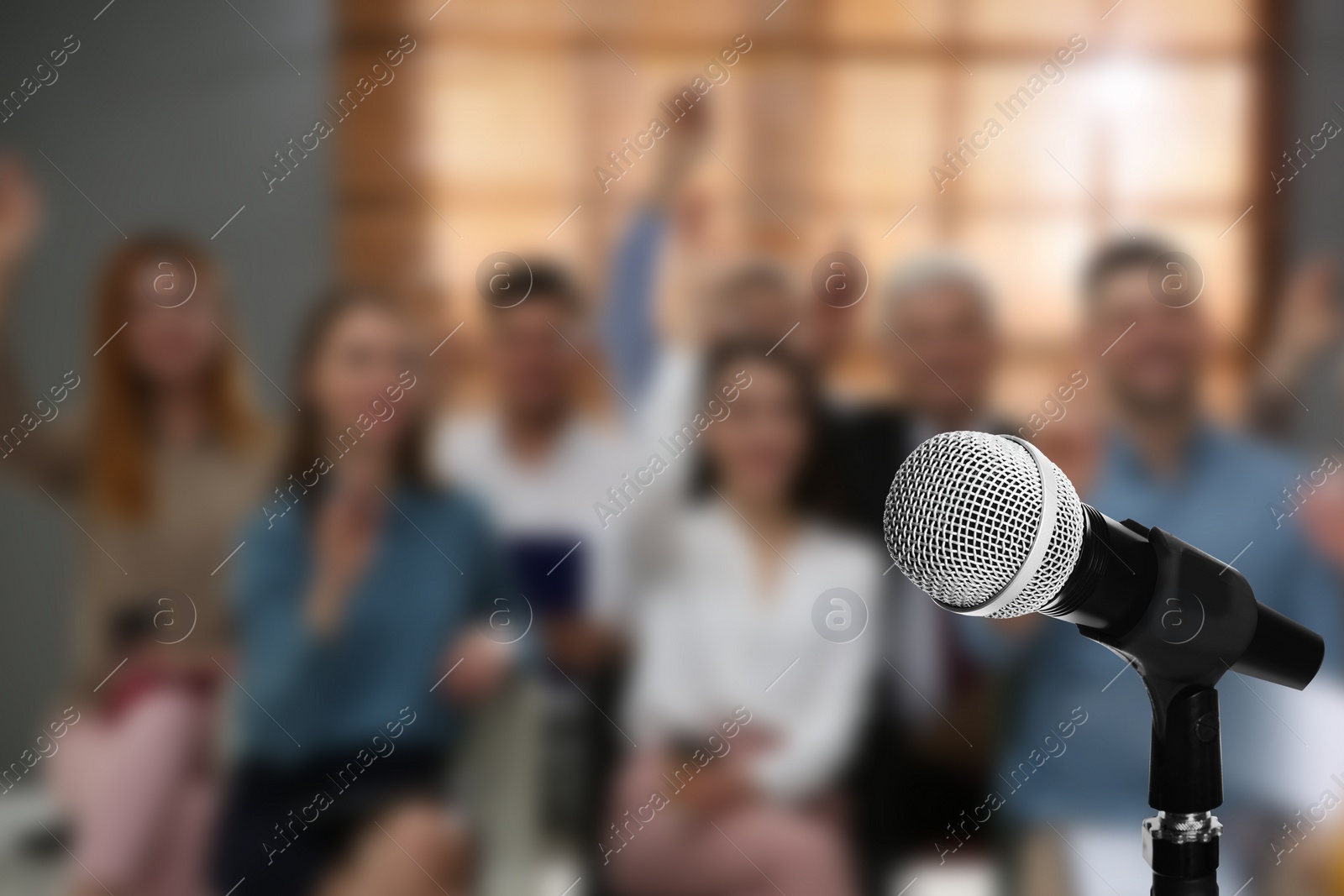 Image of Modern microphone and people at business training indoors, closeup