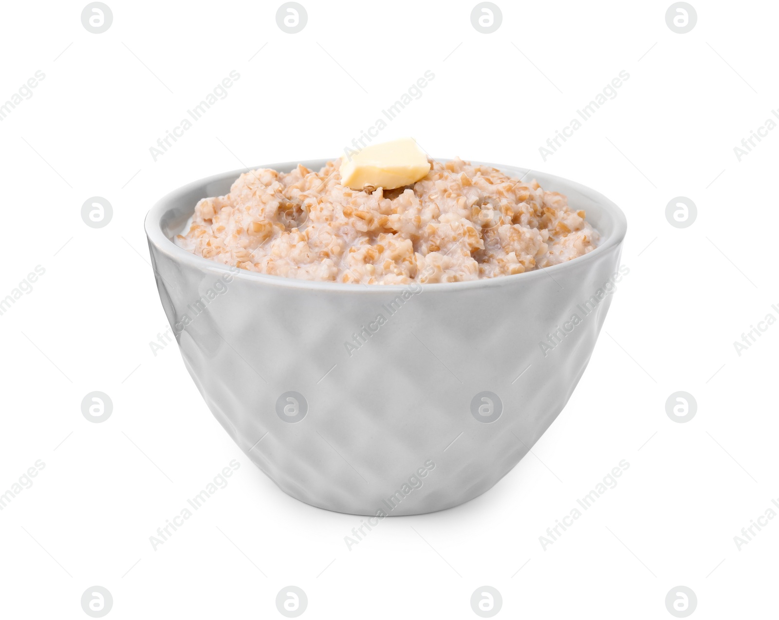 Photo of Tasty wheat porridge with milk and butter in bowl isolated on white