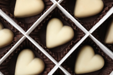 Tasty heart shaped chocolate candies in box, top view. Valentine's day celebration