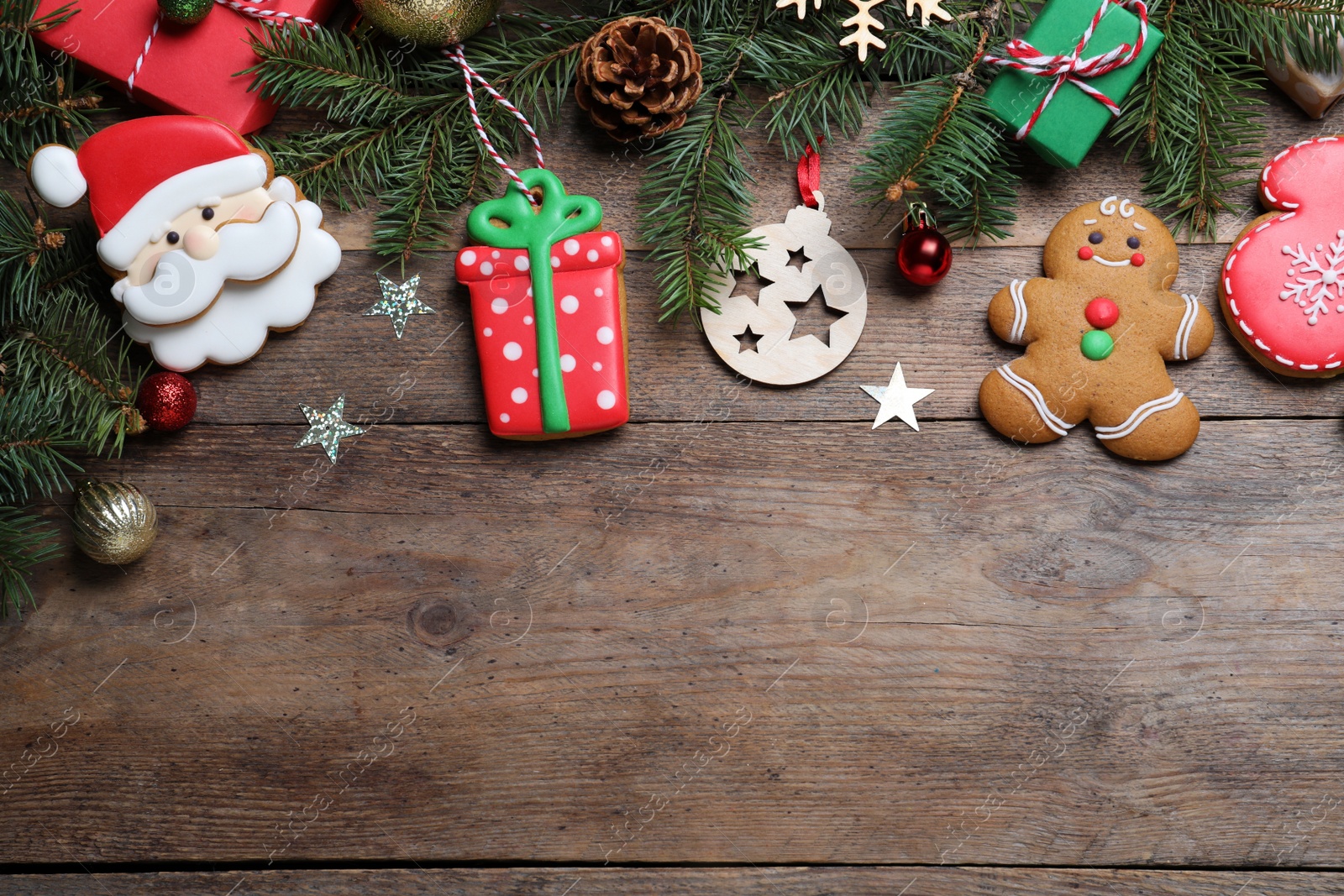 Photo of Flat lay composition with tasty Christmas cookies on wooden table, space for text