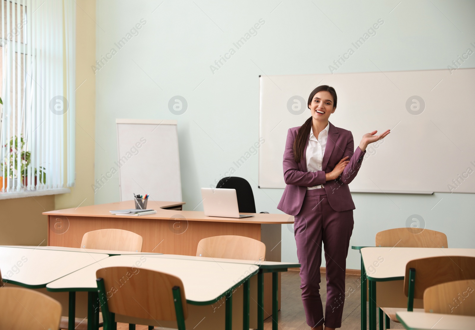 Photo of Portrait of female teacher in modern classroom