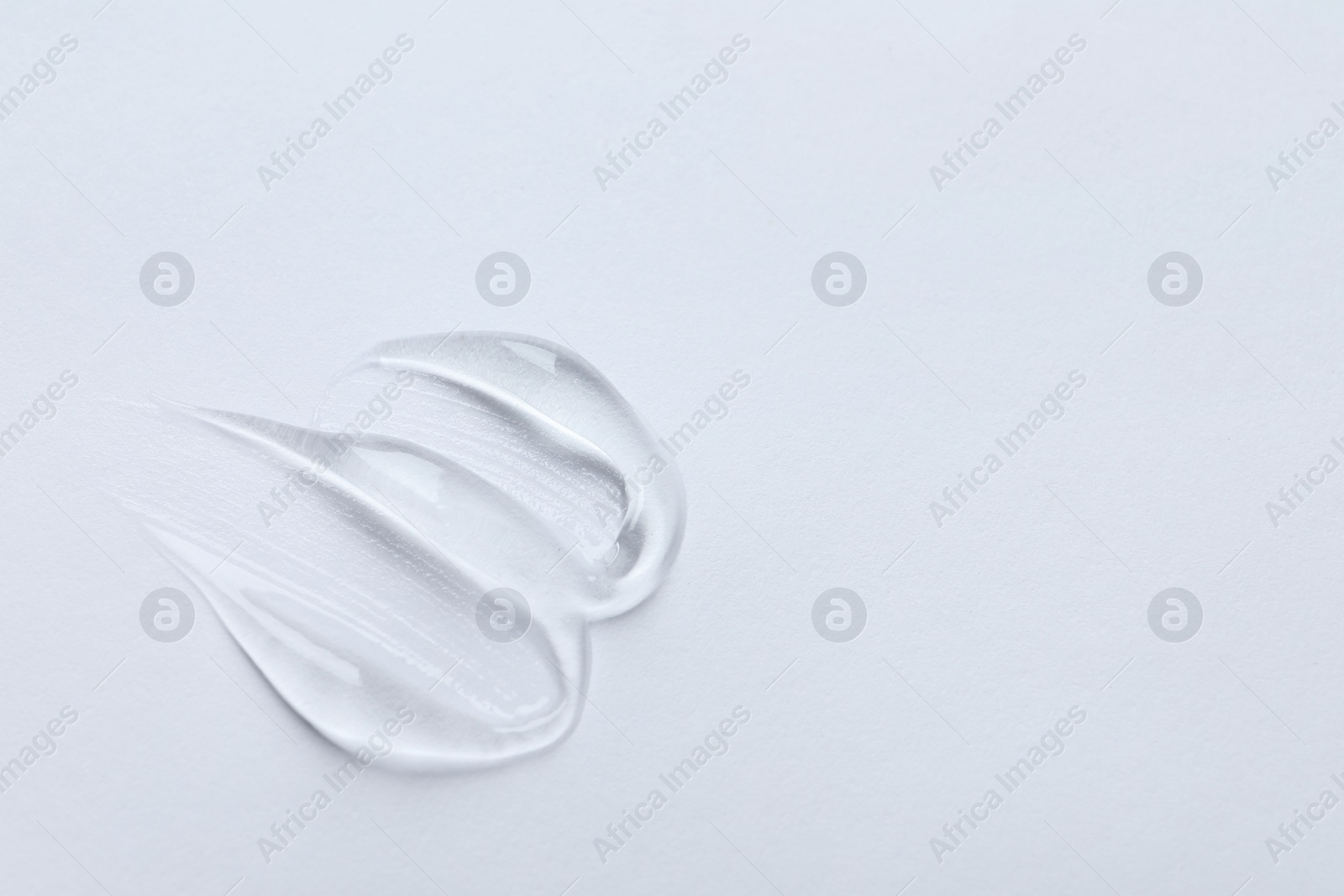 Photo of Swatches of cosmetic gel on white background, top view