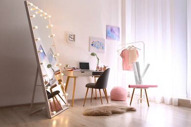 Photo of Large mirror with light bulbs in stylish room interior