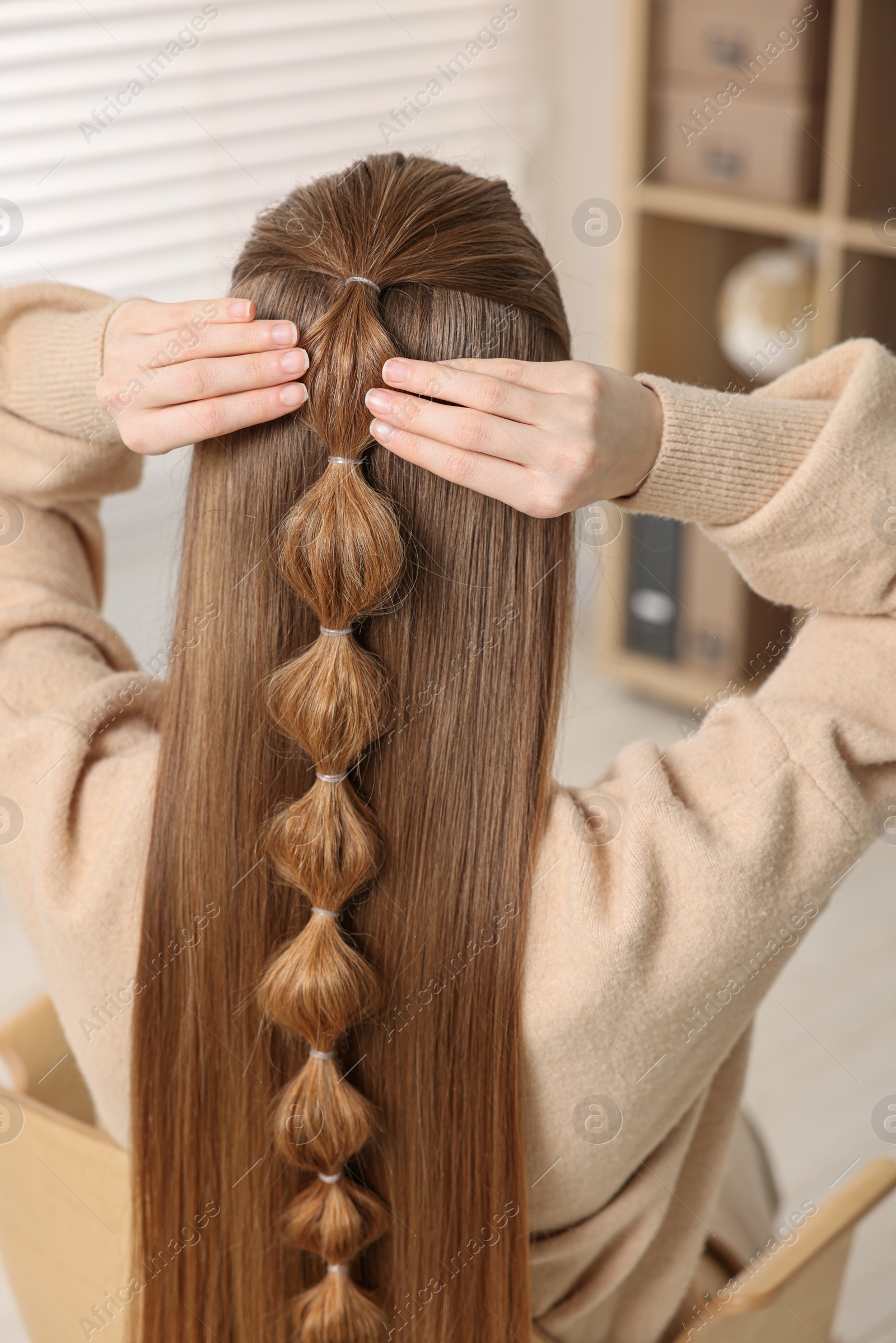 Photo of Woman with braided hair indoors, back view