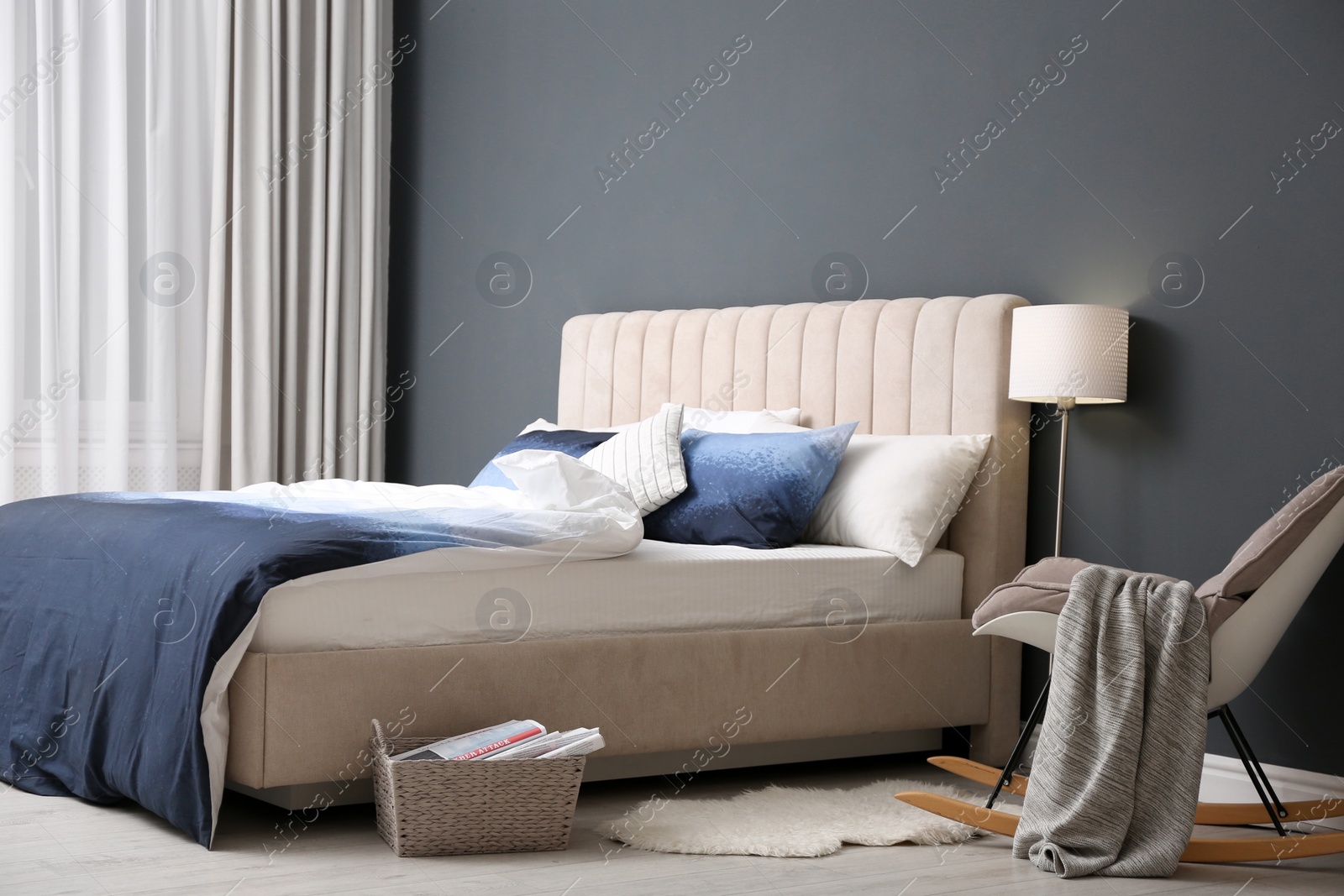 Photo of Comfortable bed with pillows and soft blanket in room. Stylish interior design