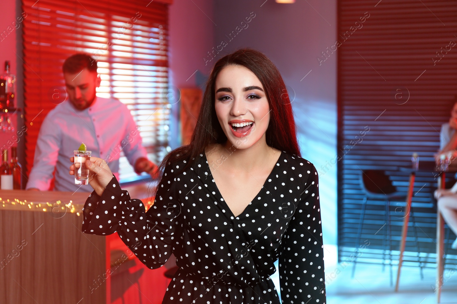 Photo of Young woman with Mexican Tequila shot in bar