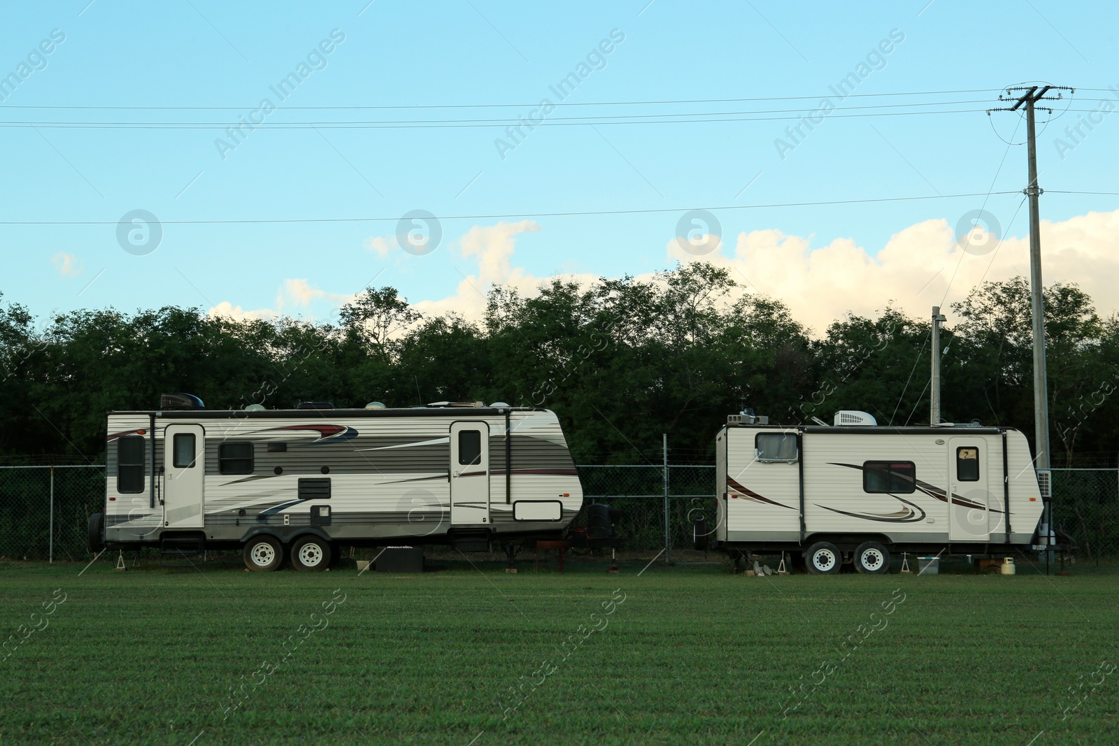 Photo of Travel trailers parked outdoors. Home on wheels