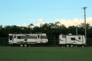 Photo of Travel trailers parked outdoors. Home on wheels