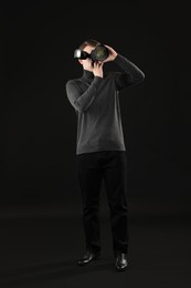 Professional photographer taking picture on black background