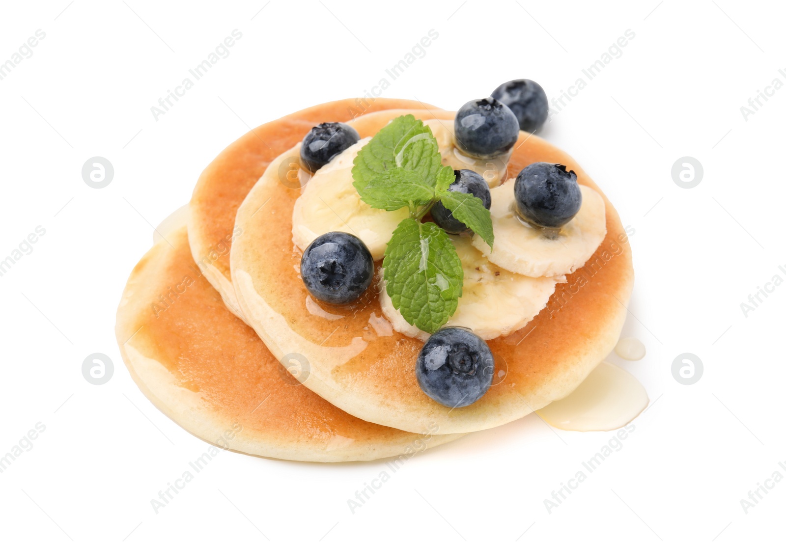 Photo of Delicious pancakes with banana slices, blueberries and mint isolated on white