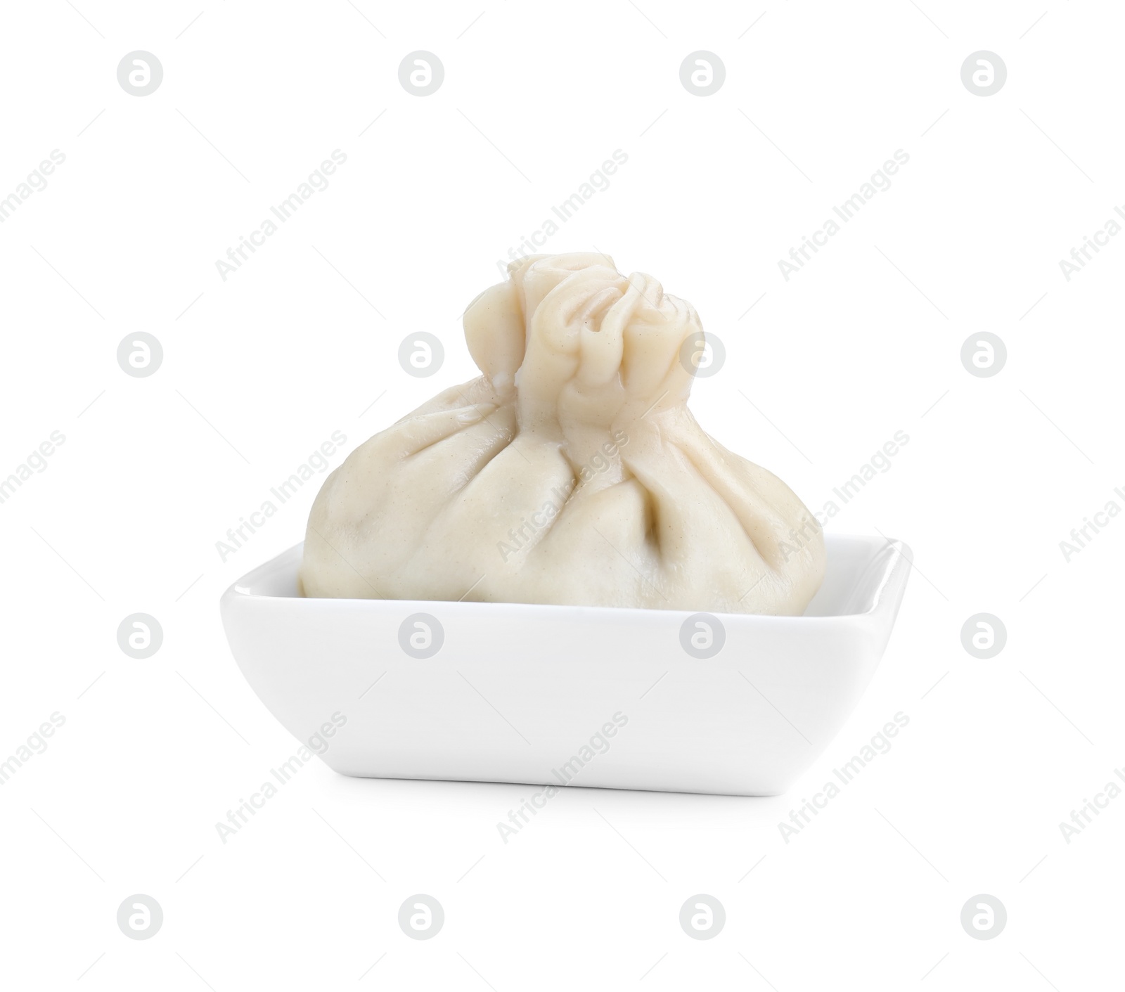 Photo of One tasty khinkali (dumpling) in bowl isolated on white. Georgian cuisine