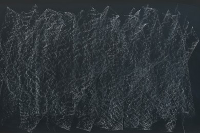 Photo of Dirty black chalkboard as background. School equipment