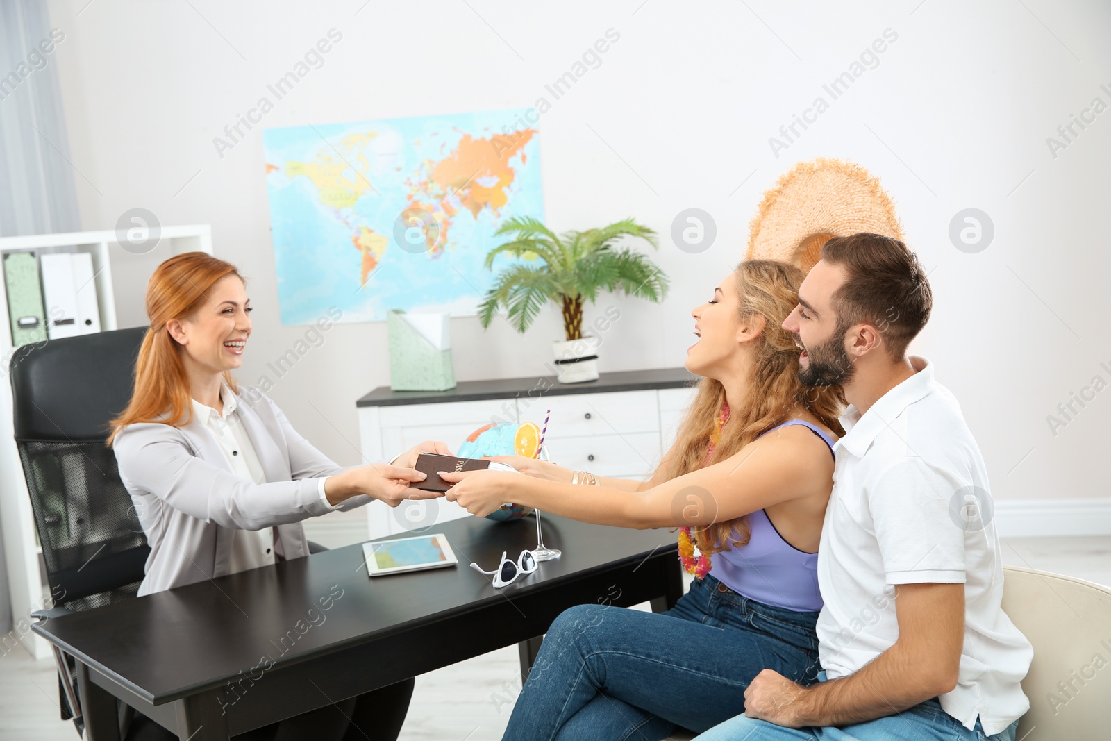 Photo of Beautiful young couple visiting travel agency office