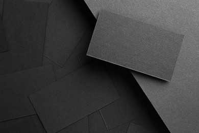 Photo of Blank business cards on black background, flat lay. Mockup for design