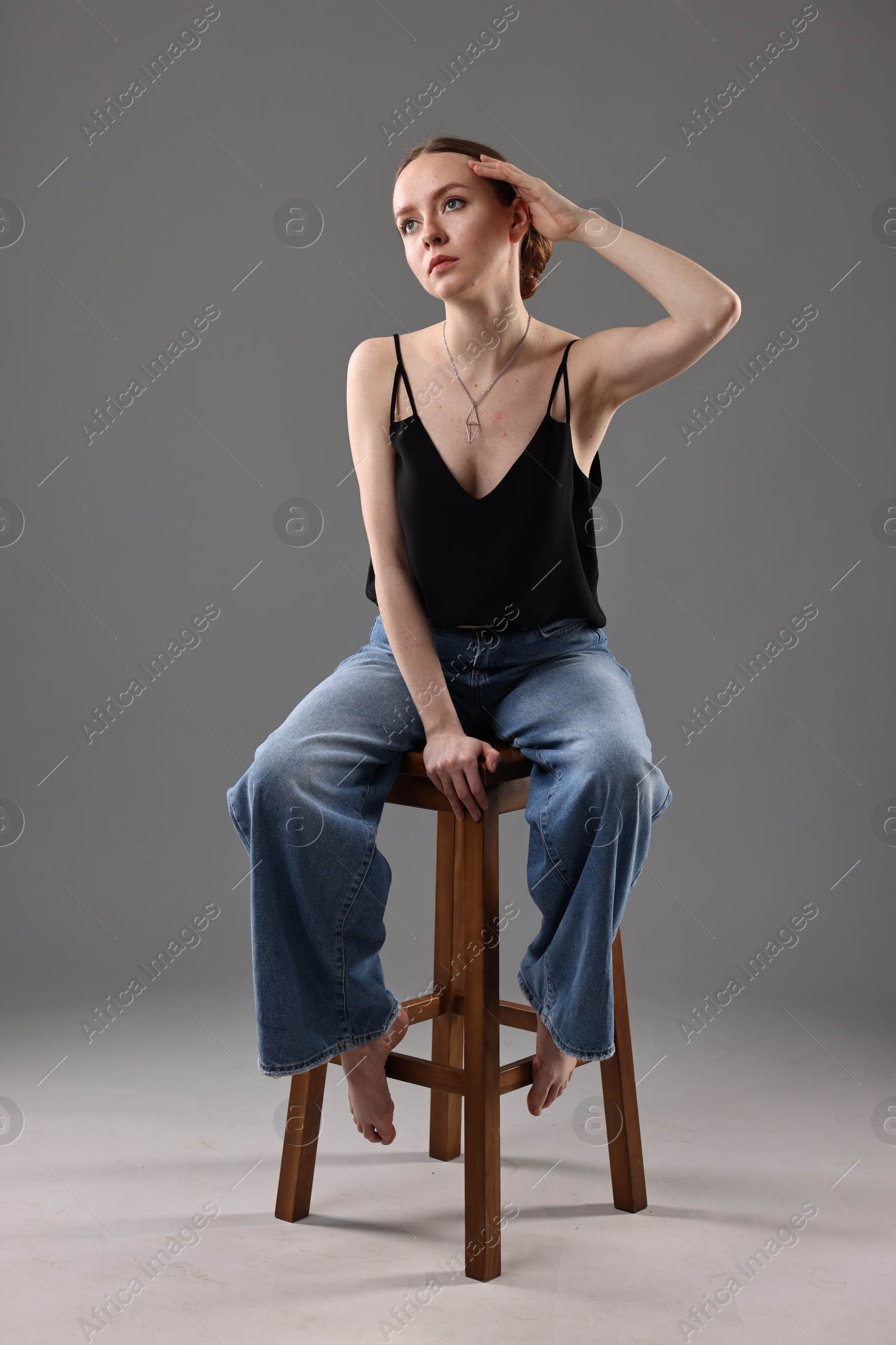 Photo of Fashionable portrait of beautiful young woman on grey background