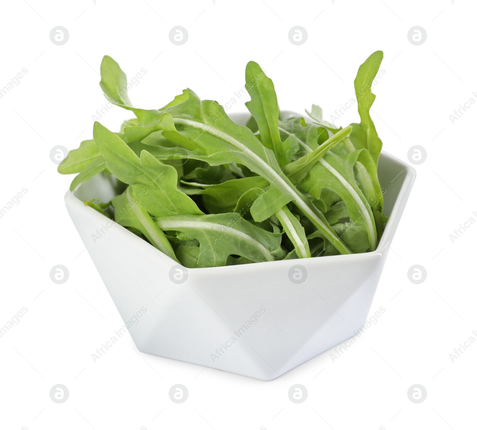 Photo of Delicious fresh arugula in bowl isolated on white