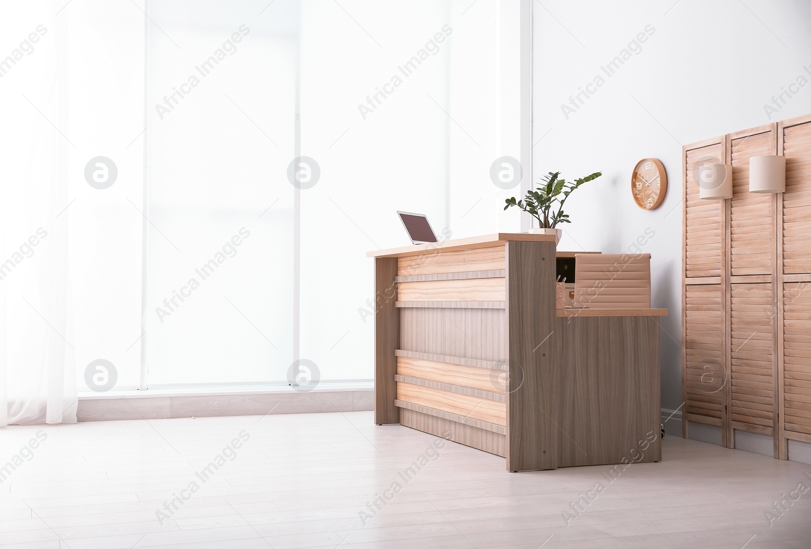 Photo of Hotel lobby interior with wooden reception desk