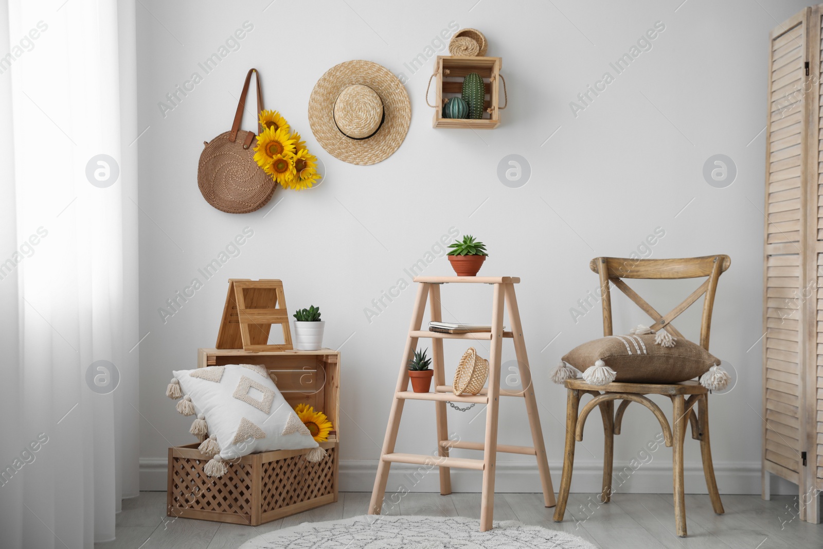 Photo of Bag with bouquet of beautiful sunflowers in stylish room interior