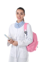 Young medical student with notebooks and backpack on white background