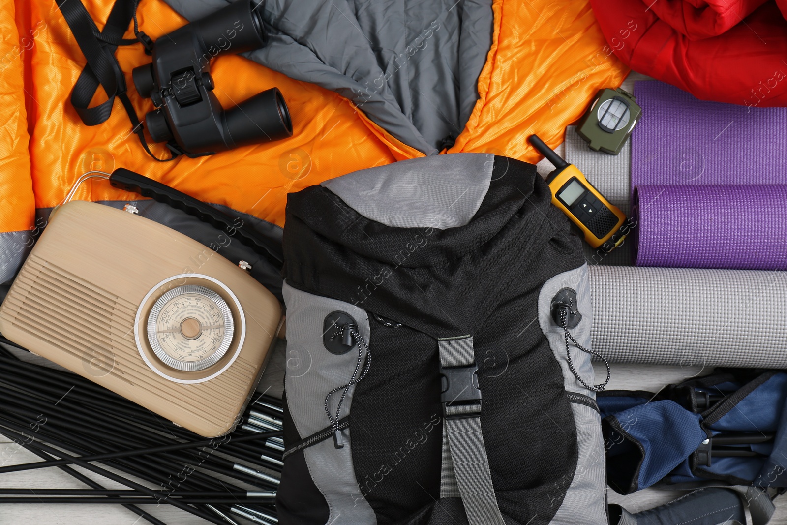 Photo of Composition with sleeping bag and camping equipment as background