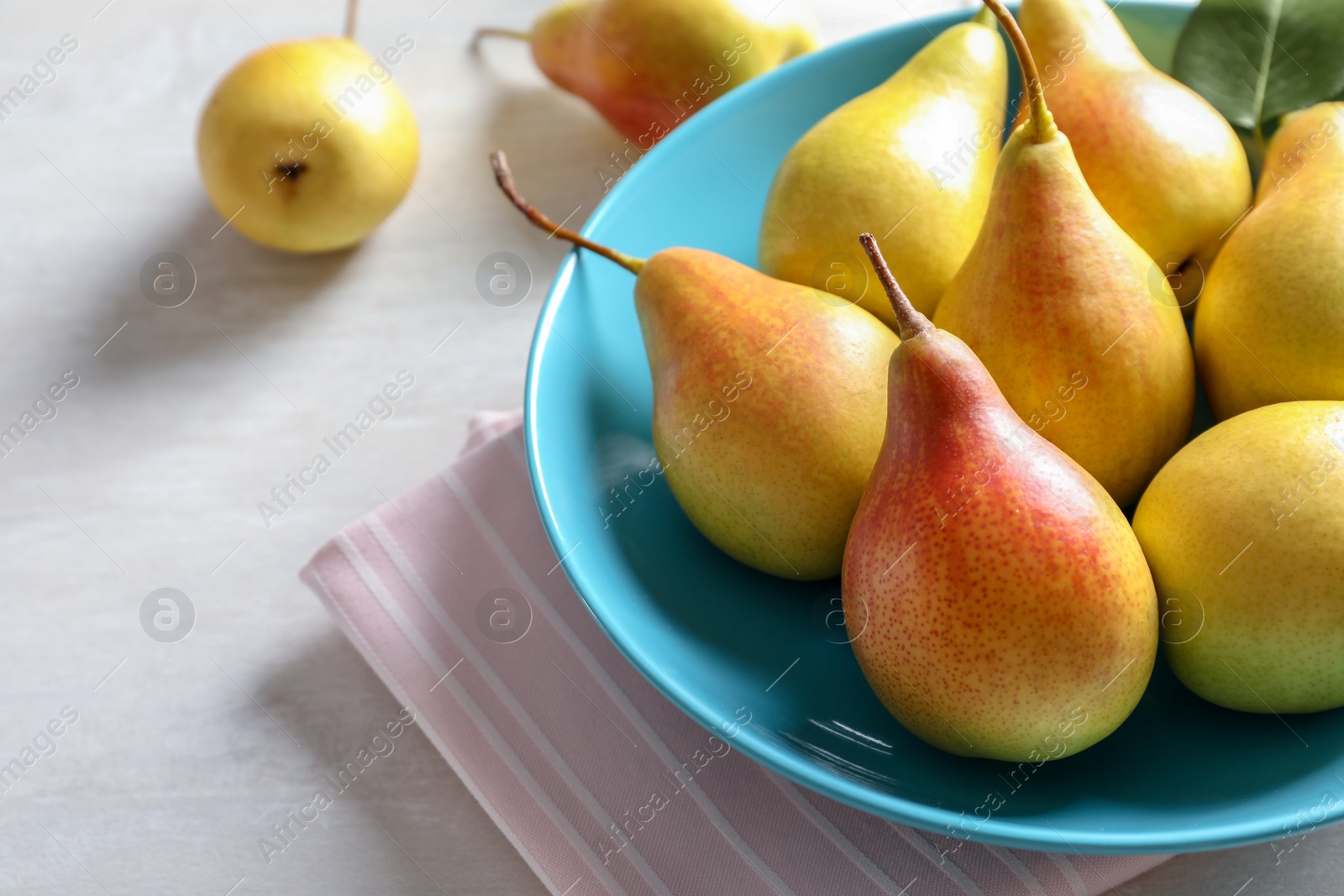 Photo of Plate with ripe pears on table, closeup. Space for text