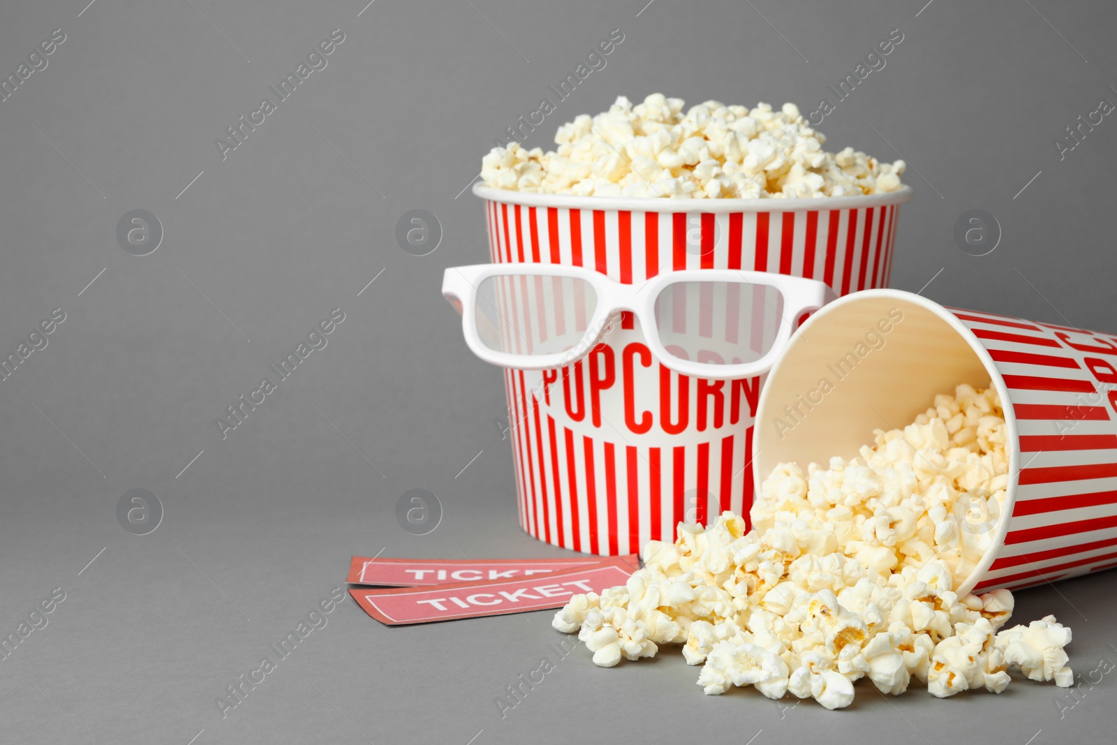 Photo of Popcorn, cinema tickets and 3d glasses on grey background. Space for text