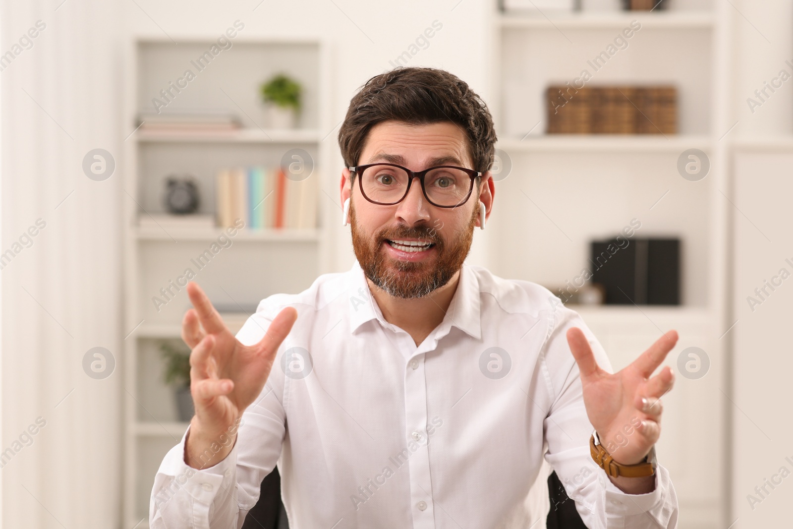 Photo of Emotional businessman having online video call indoors, view from web camera