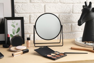 Dressing table with mirror, makeup products and accessories in room