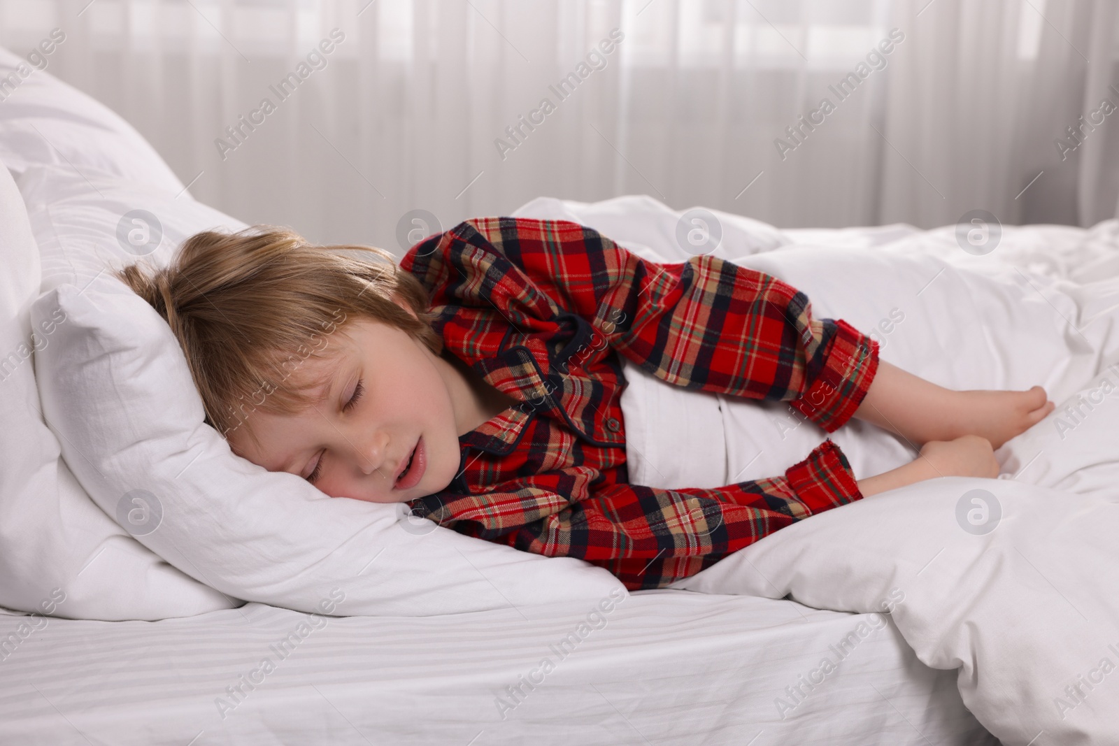 Photo of Little boy snoring while sleeping in bed at home