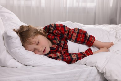 Little boy snoring while sleeping in bed at home