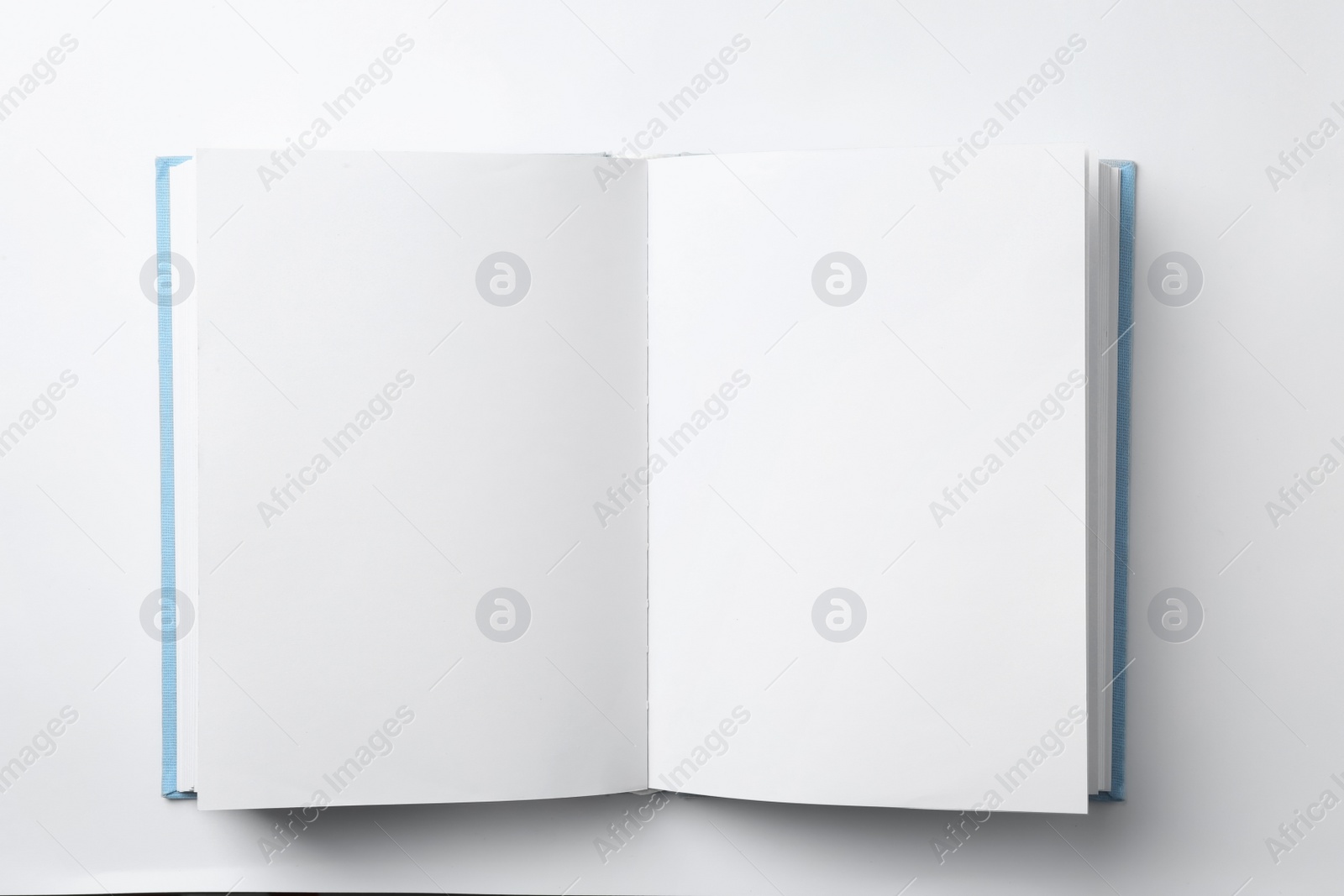 Photo of Mockup of open book on white background, top view