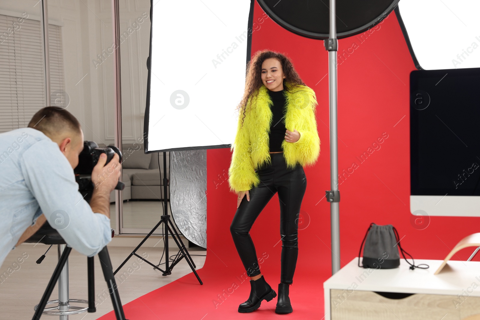 Photo of Beautiful African American model posing for professional photographer in studio