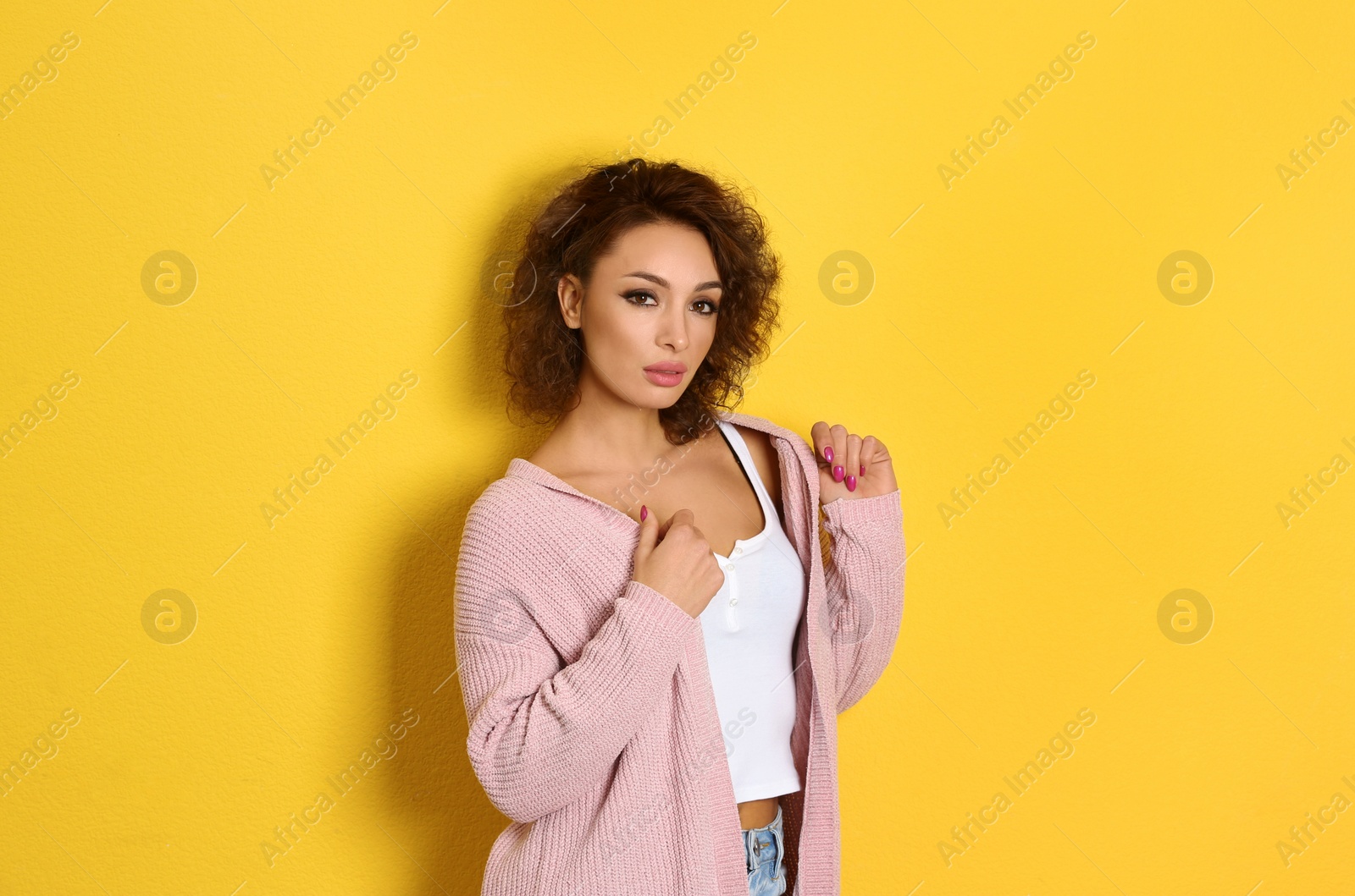 Photo of Beautiful woman in casual outfit on yellow background