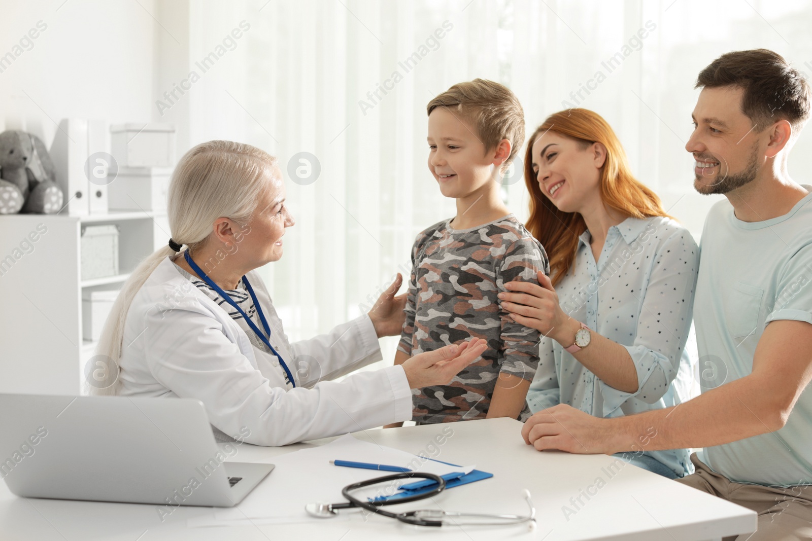 Photo of Family with child visiting doctor in hospital