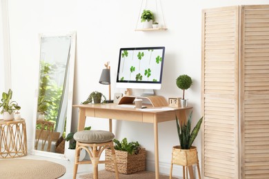 Photo of Stylish room interior with comfortable workplace. Home office