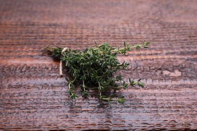 Photo of Bunch of fresh thyme on wooden table