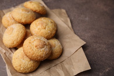 Photo of Tasty sweet sugar cookies on brown table, closeup