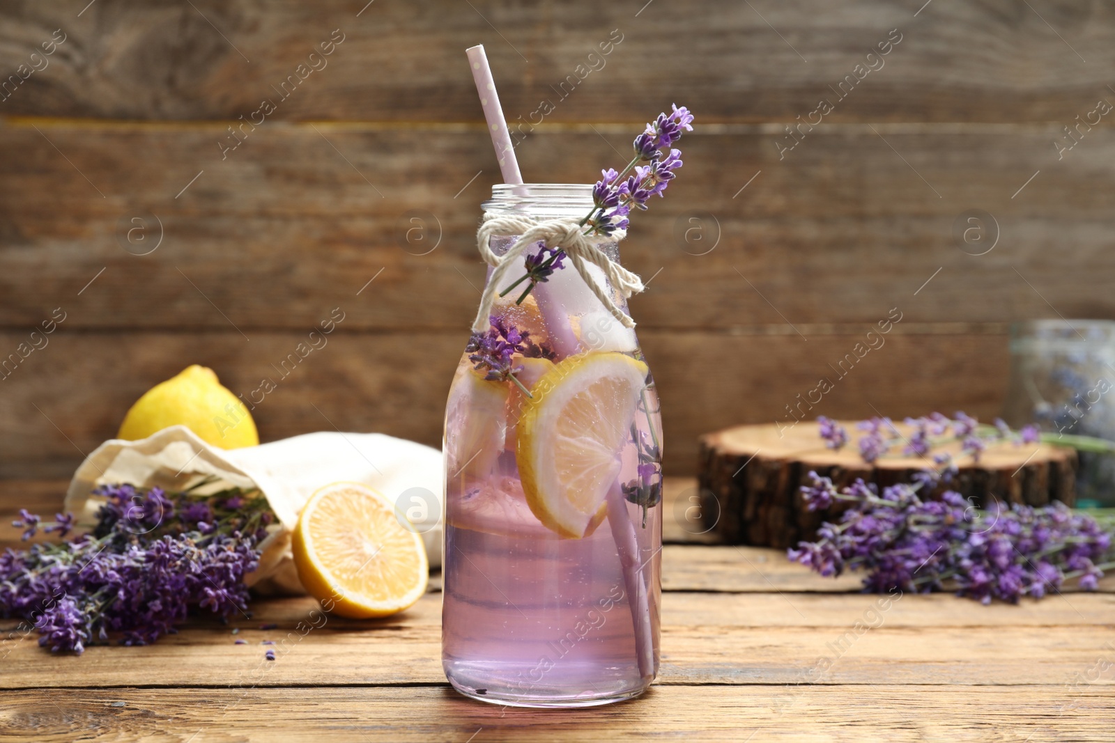 Photo of Fresh delicious lemonade with lavender on wooden table