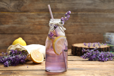 Photo of Fresh delicious lemonade with lavender on wooden table