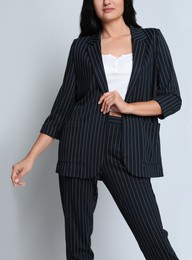 Photo of Woman in formal suit on light background, closeup. Business attire