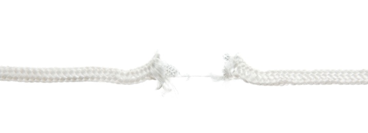 Frayed rope at breaking point on white background