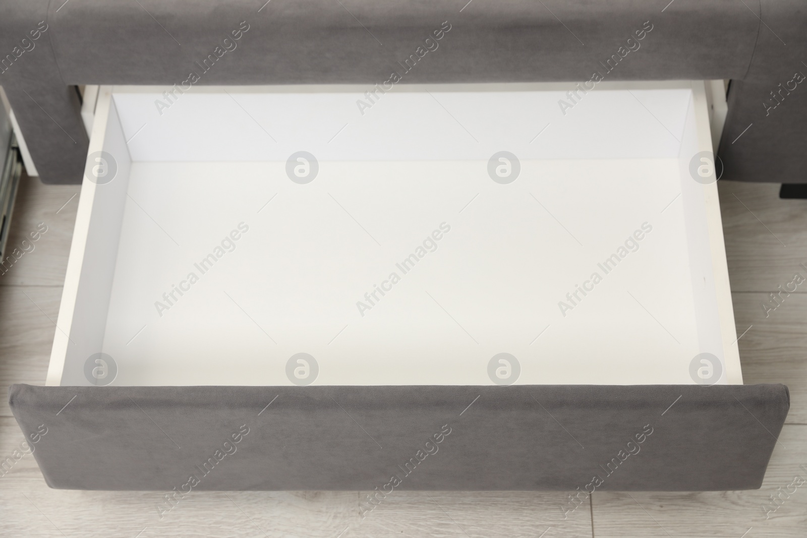 Photo of Storage drawer for bedding under modern bed in room, above view