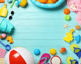 Photo of Flat lay composition with beach toys on color wooden background. Space for text