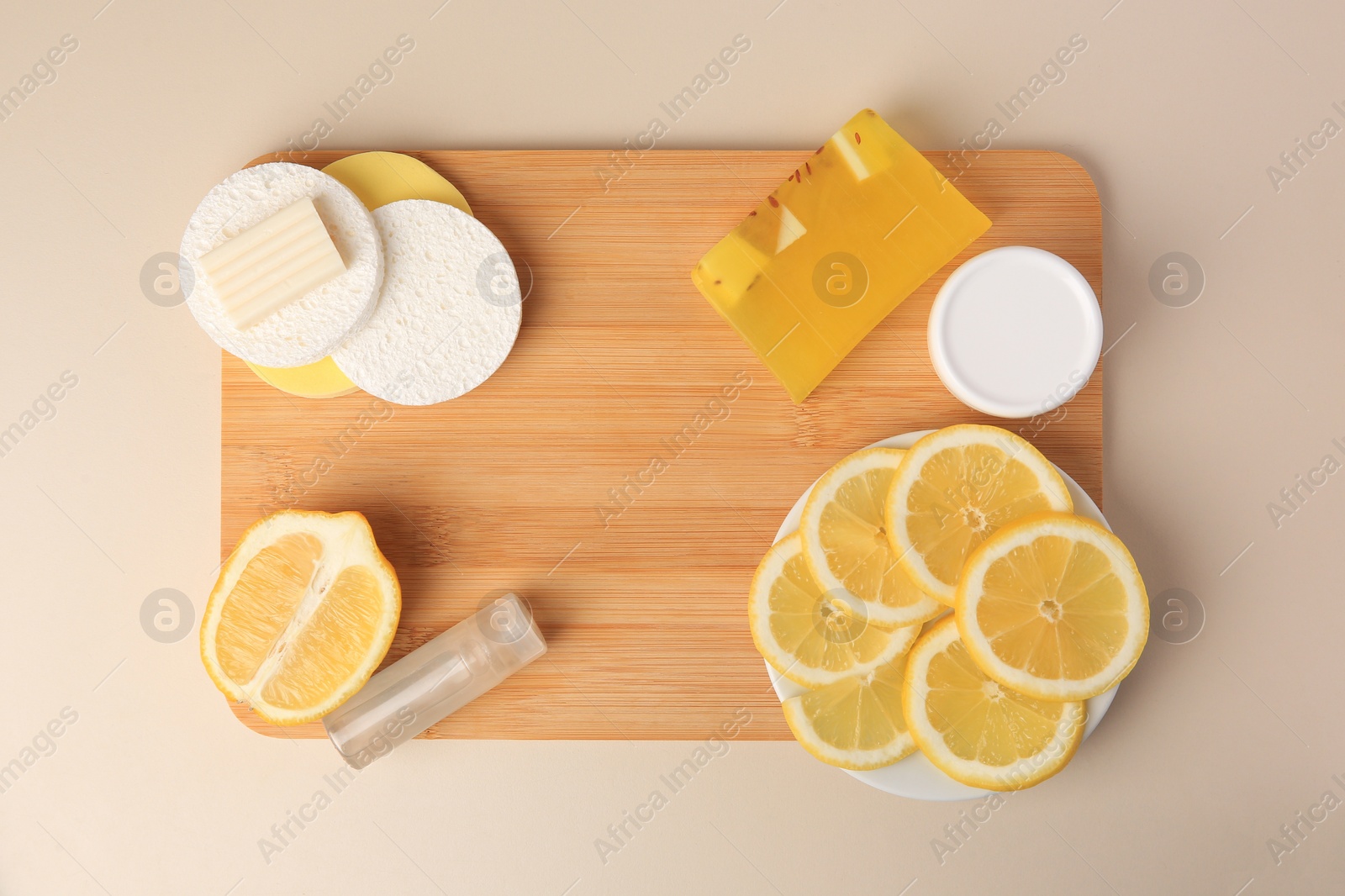 Photo of Lemon face cleanser. Fresh citrus fruits and personal care products on beige background, top view