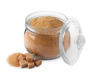 Photo of Granulated and cubed brown sugar with jar on white background