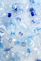 Many used plastic bottles as background, top view. Recycling problem