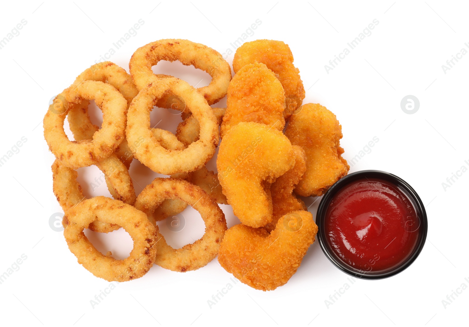 Photo of Tasty fried onion rings, chicken nuggets and ketchup on white background, top view