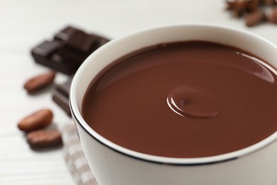 Photo of Yummy hot chocolate in cup on table, closeup