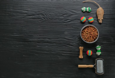 Photo of Flat lay composition with cat accessories and food on dark wooden background