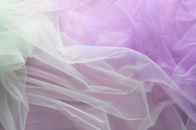 Beautiful tulle fabric on lilac background, flat lay